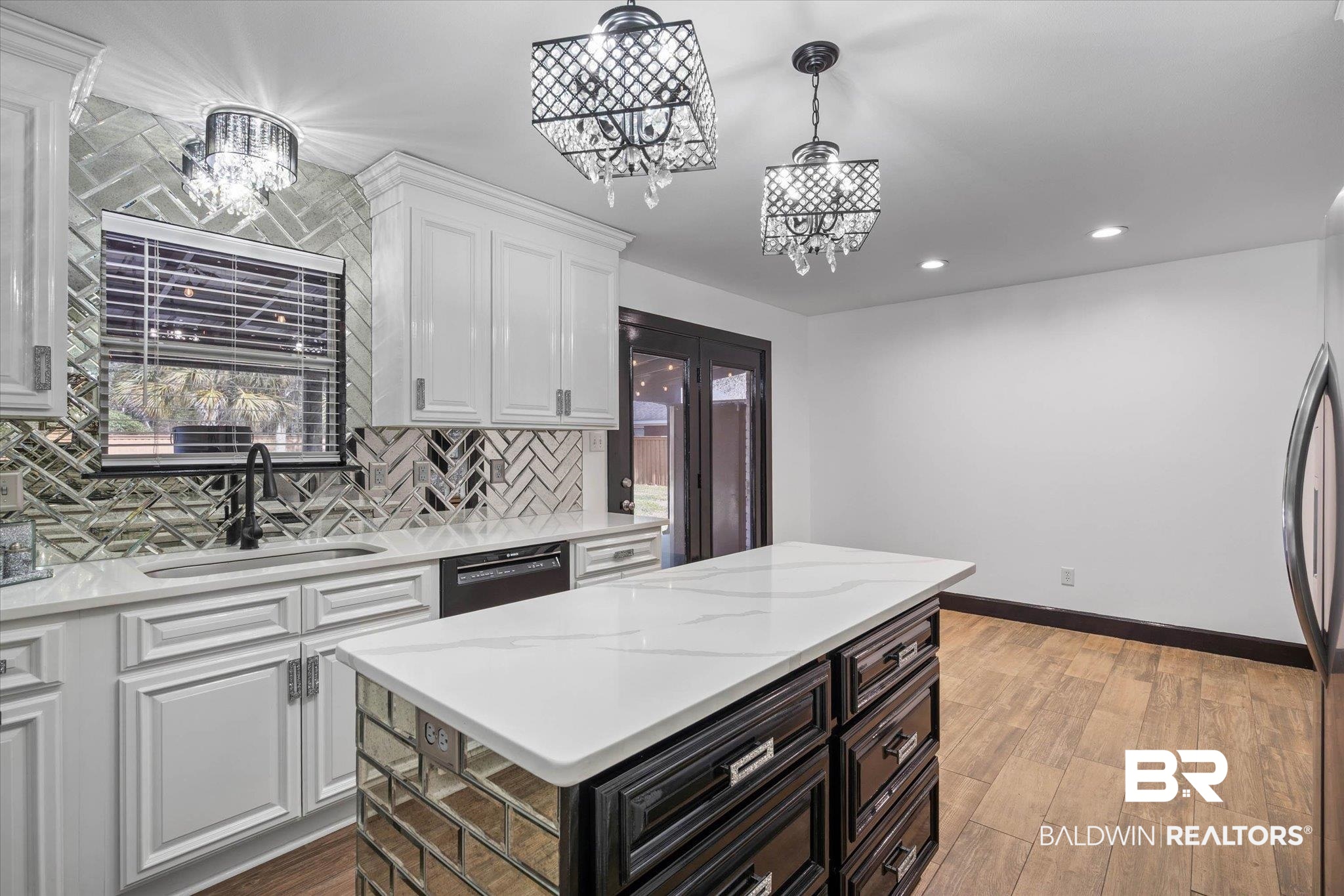 3216 Bay Booster Club Road Theodore, AL 36582 - Photo 9 of 46 Dual tone kitchen featuring decorative backsplash, light stone countertops, light wood-style floors, a kitchen island, and two tone color scheme