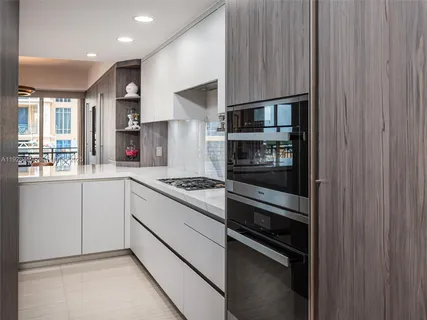 a kitchen with stainless steel appliances a refrigerator and a stove top oven