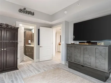 a view of a livingroom with wooden floor and a flat screen tv