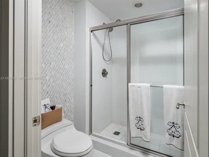 a bathroom with a toilet and shower