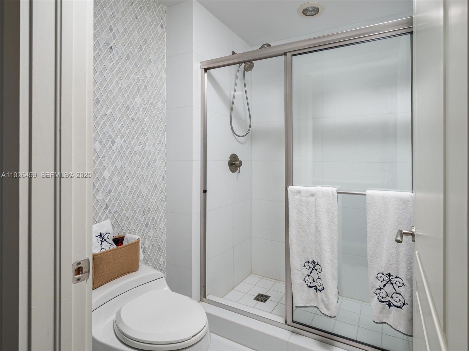 3415 North Ocean Drive, Unit 605 Hollywood, FL 33019 - Photo 21 of 31 a bathroom with a toilet and shower