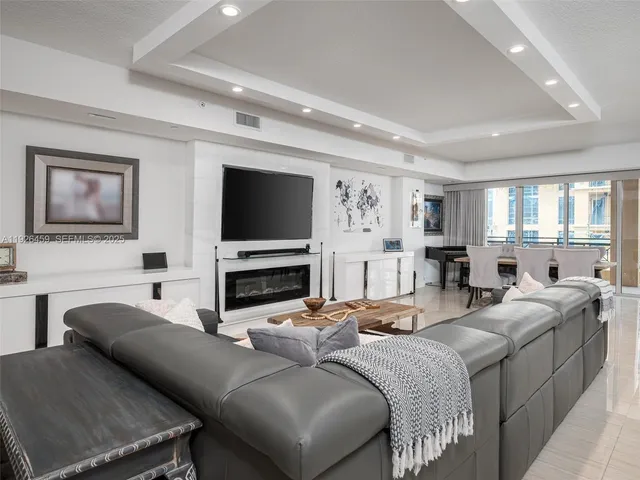 a living room with fireplace furniture and a flat screen tv