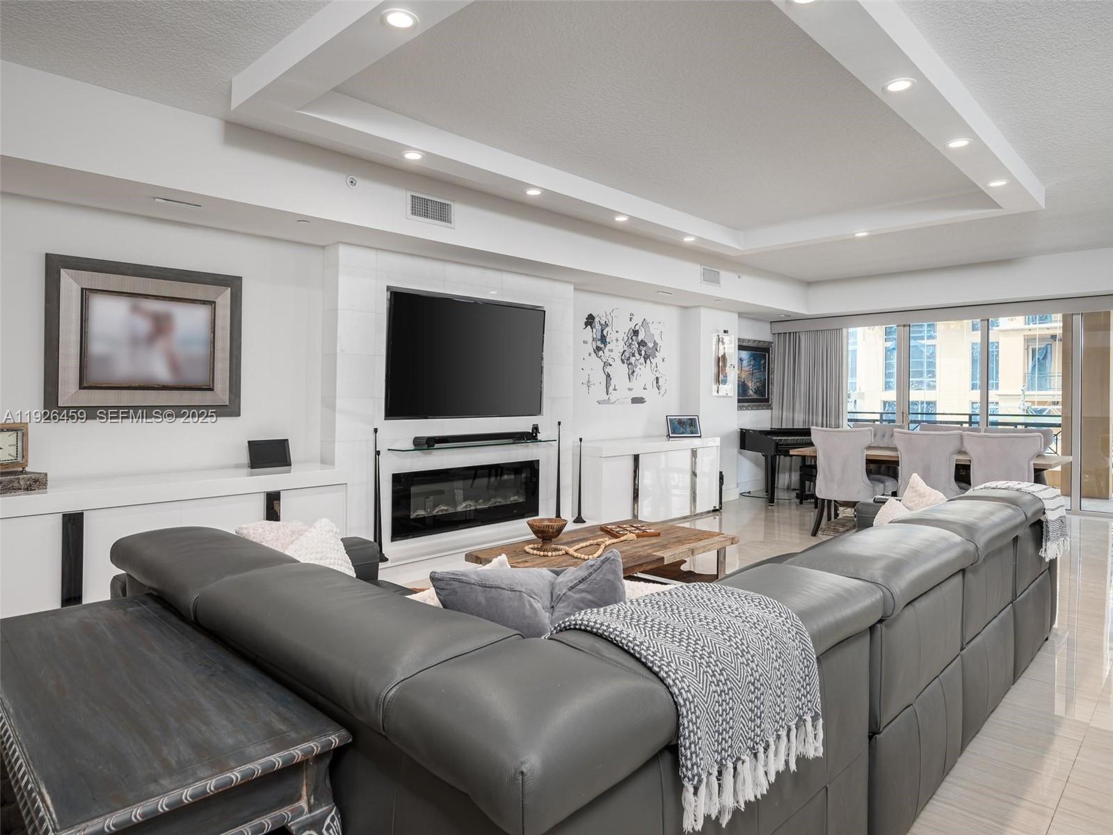 3415 North Ocean Drive, Unit 605 Hollywood, FL 33019 - Photo 3 of 31 a living room with fireplace furniture and a flat screen tv