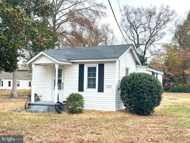 a view of a house with a yard covered in snow