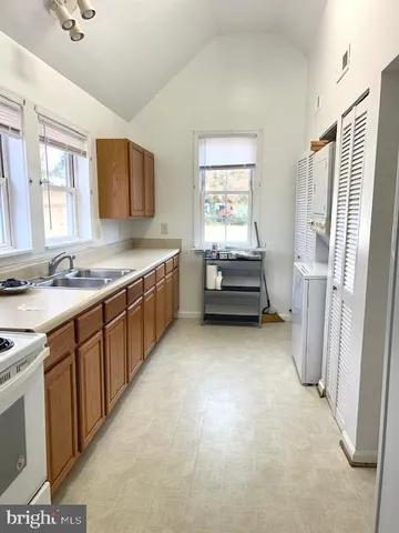 a kitchen with cabinets and window
