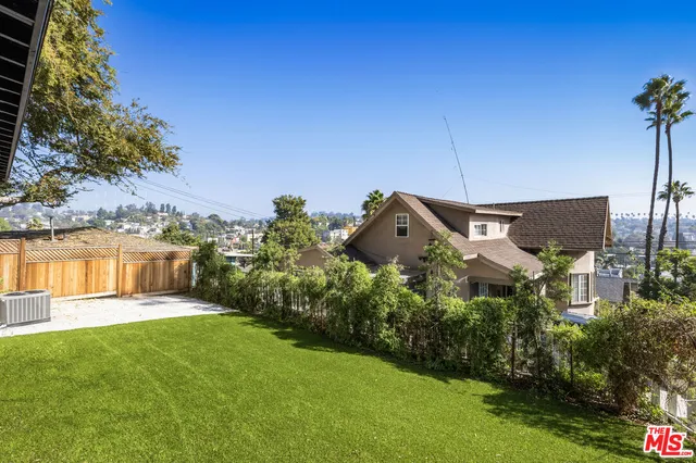 a view of a garden with a house