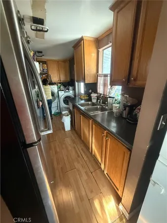 a kitchen with sink a refrigerator a stove a washer and dryer