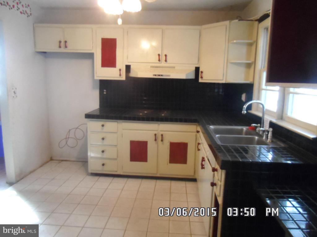 834 Orems Road Baltimore, MD 21221 - Photo 11 of 15 a kitchen with stainless steel appliances granite countertop a sink and a stove