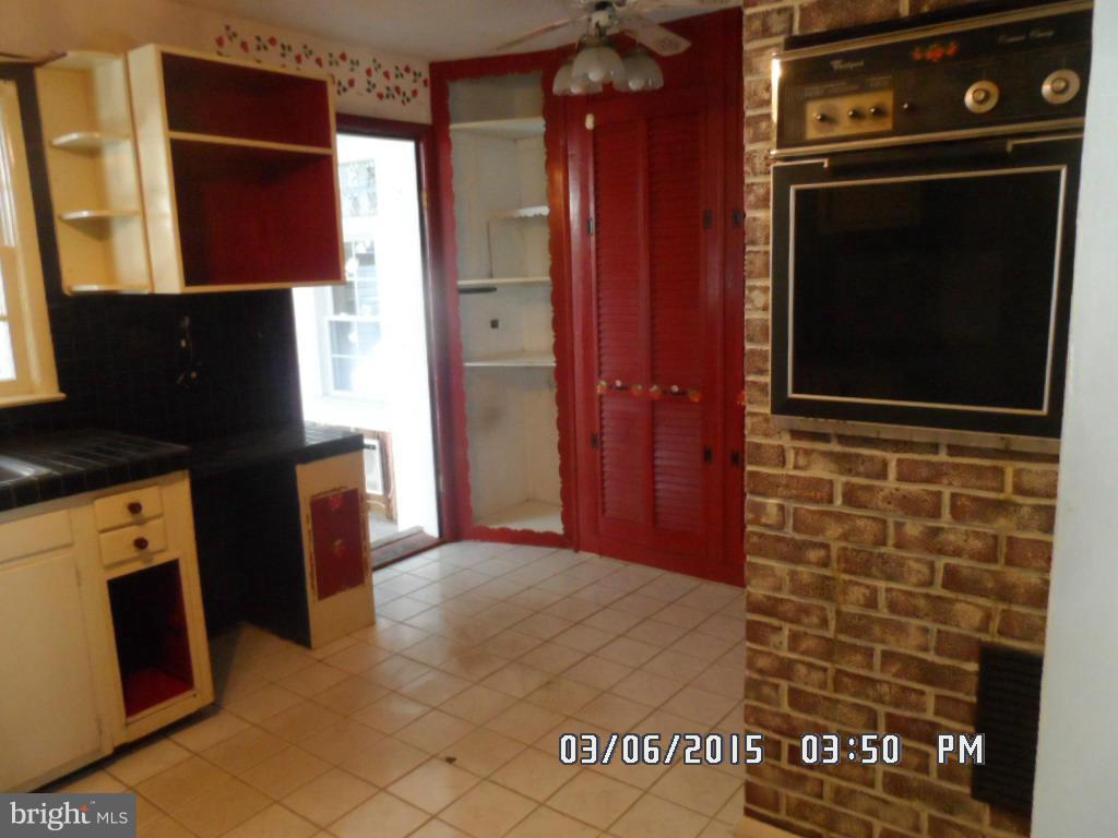 834 Orems Road Baltimore, MD 21221 - Photo 10 of 15 a kitchen with granite countertop white cabinets and stainless steel appliances