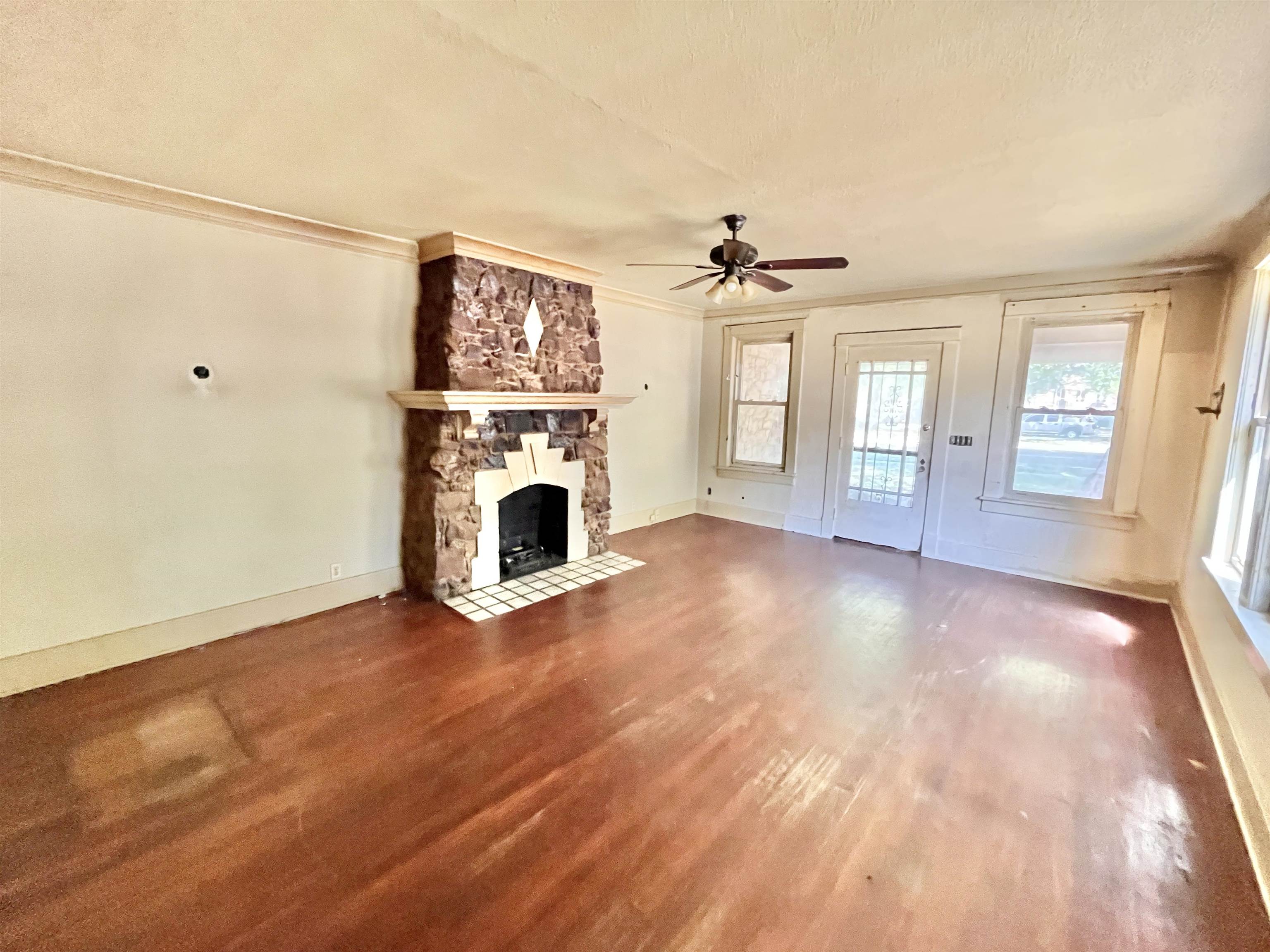 791 E Parkway South Memphis, TN 38104 - Photo 14 of 17 a view of livingroom with furniture a fireplace and wooden floor