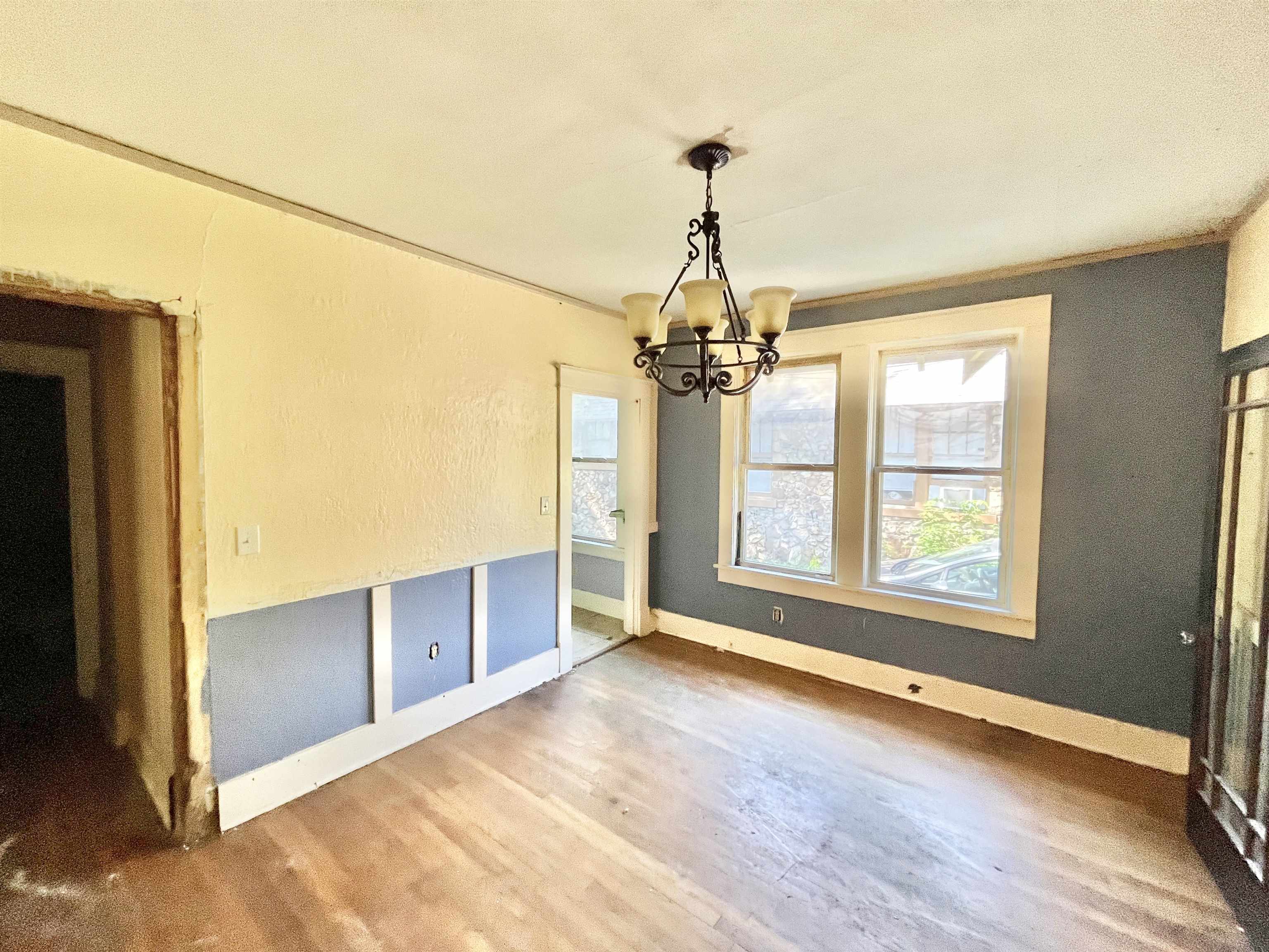 791 E Parkway South Memphis, TN 38104 - Photo 5 of 17 an empty room with wooden floor chandelier and windows