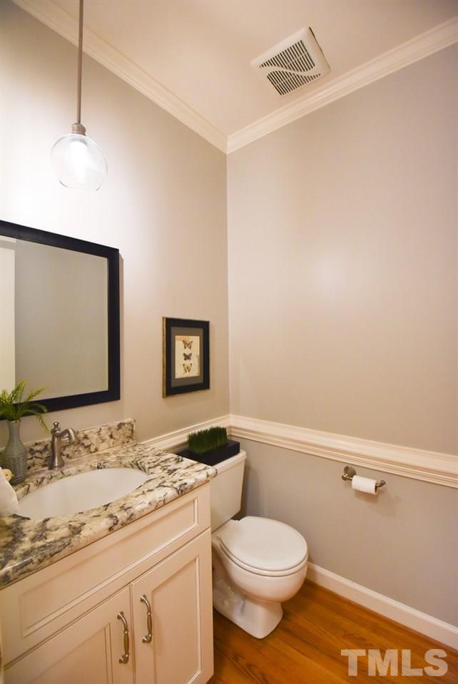 9004 Enfield Court Raleigh, NC 27615 - Photo 14 of 30 Updated Half Bath w/hardwood floor & pendant-topped granite vanity.