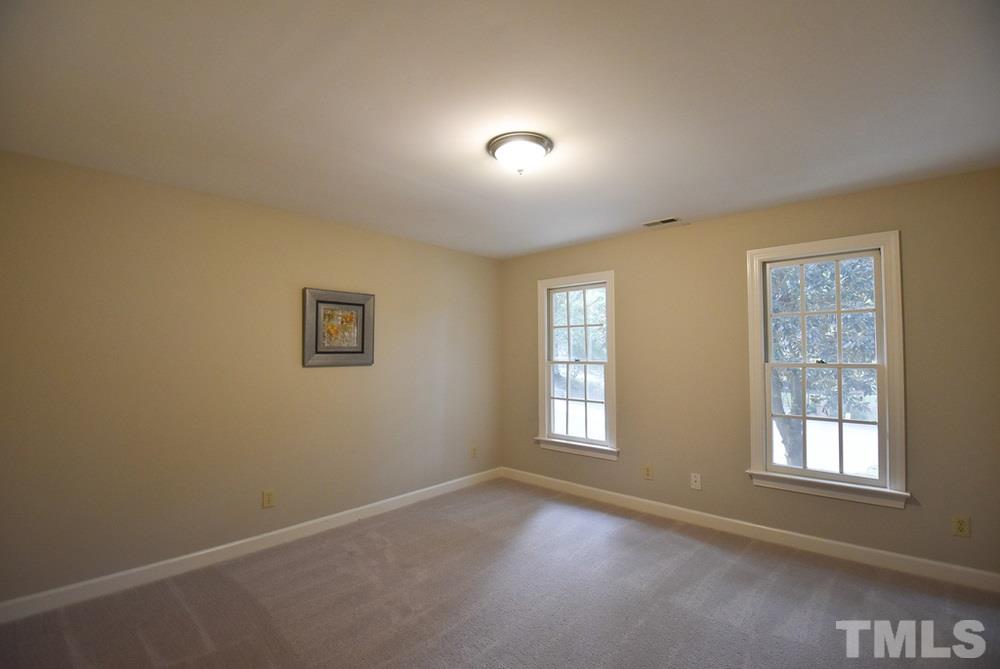 9004 Enfield Court Raleigh, NC 27615 - Photo 20 of 30 There are 2 add’l spacious Bedrooms w/neutral carpet & WICs on the 2nd level. This is Bedroom 2.