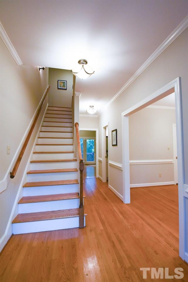 9004 Enfield Court Raleigh, NC 27615 - Photo 3 of 30 9' ceilings, nice moldings & hardwood flrs throughout main level; central vac. Gracious Foyer w/hardwood flr, crown/chair rail molding, arched transom window above front door, coat closet & wooden steps to 2nd floor.