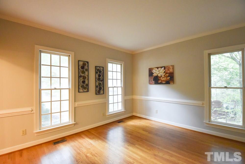 9004 Enfield Court Raleigh, NC 27615 - Photo 6 of 30 Living Rm/Study w/hardwood flr & crown/chair rail molding opens thru pocket doors to big Family Rm.
