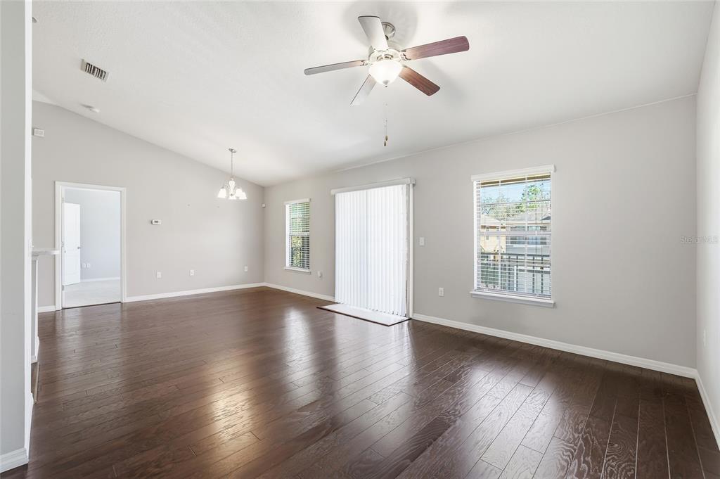 5723 Kingletsound Lithia, FL 33547 - Photo 11 of 33 a view of an empty room with wooden floor and a window