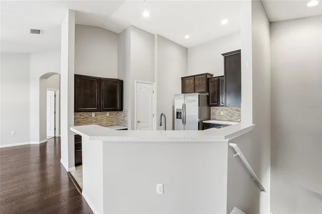 a kitchen with stainless steel appliances a refrigerator sink and microwave