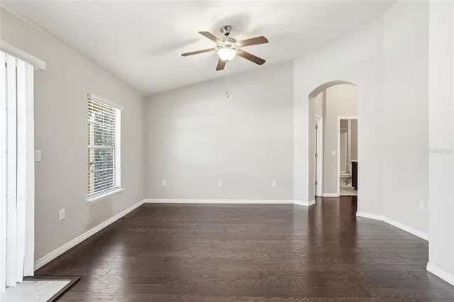 an empty room with wooden floor and a window