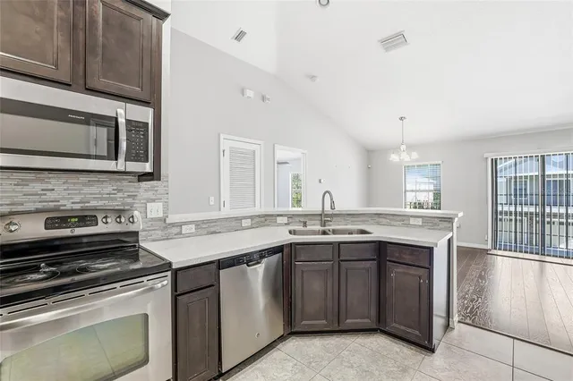 a kitchen with a sink stove and microwave