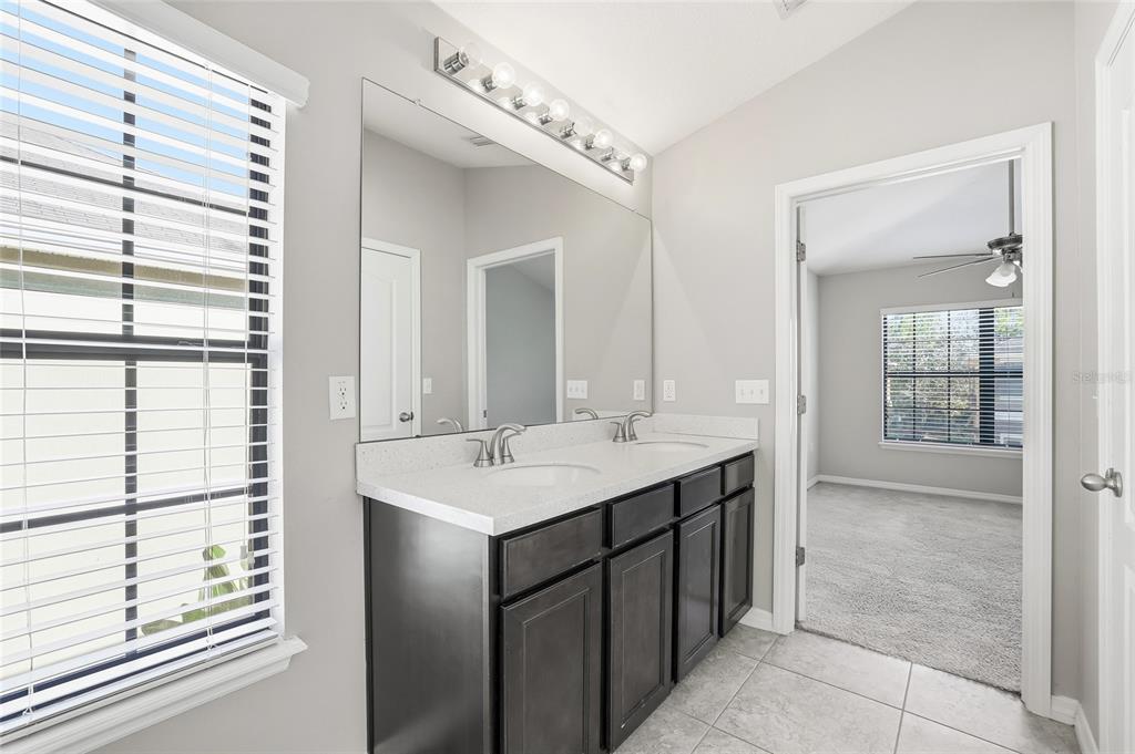 5723 Kingletsound Lithia, FL 33547 - Photo 25 of 33 a bathroom with a sink and a mirror