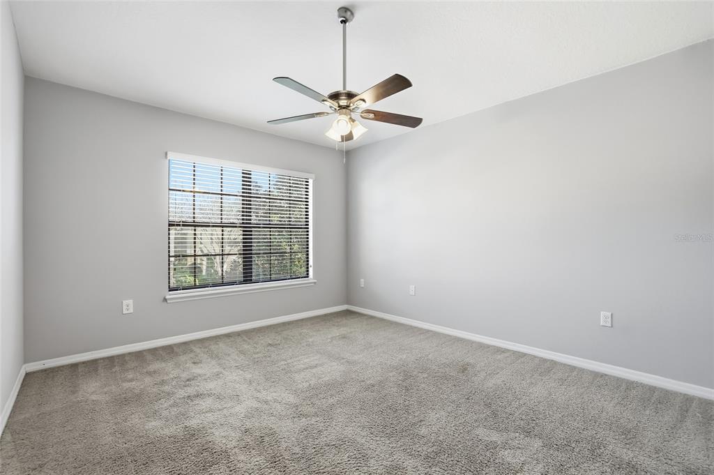 5723 Kingletsound Lithia, FL 33547 - Photo 27 of 33 an empty room with windows and fan