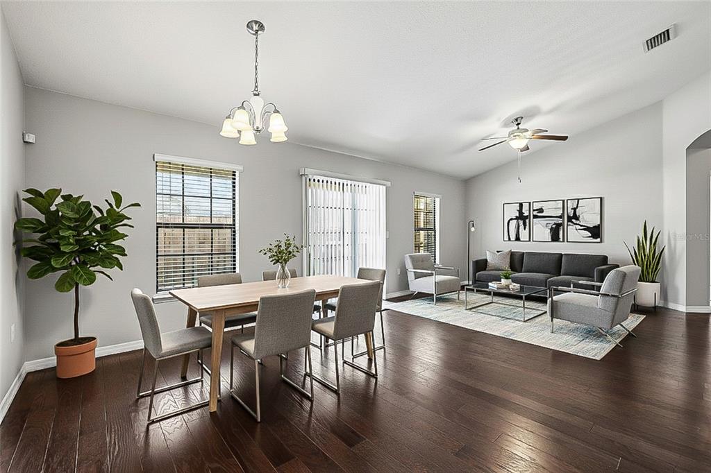 5723 Kingletsound Lithia, FL 33547 - Photo 4 of 33 a view of a dining room with furniture window and wooden floor