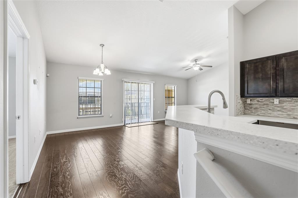 5723 Kingletsound Lithia, FL 33547 - Photo 7 of 33 a view of an empty room with wooden floor and a window