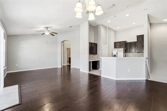 a view of a kitchen with wooden floor and a ceiling fan