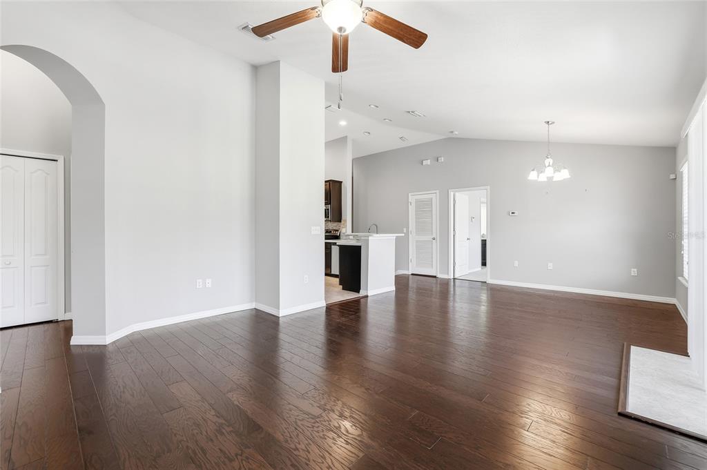 5723 Kingletsound Lithia, FL 33547 - Photo 10 of 33 a view of an empty room with wooden floor and a ceiling fan