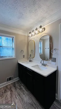 a bathroom with a double vanity sink and a mirror