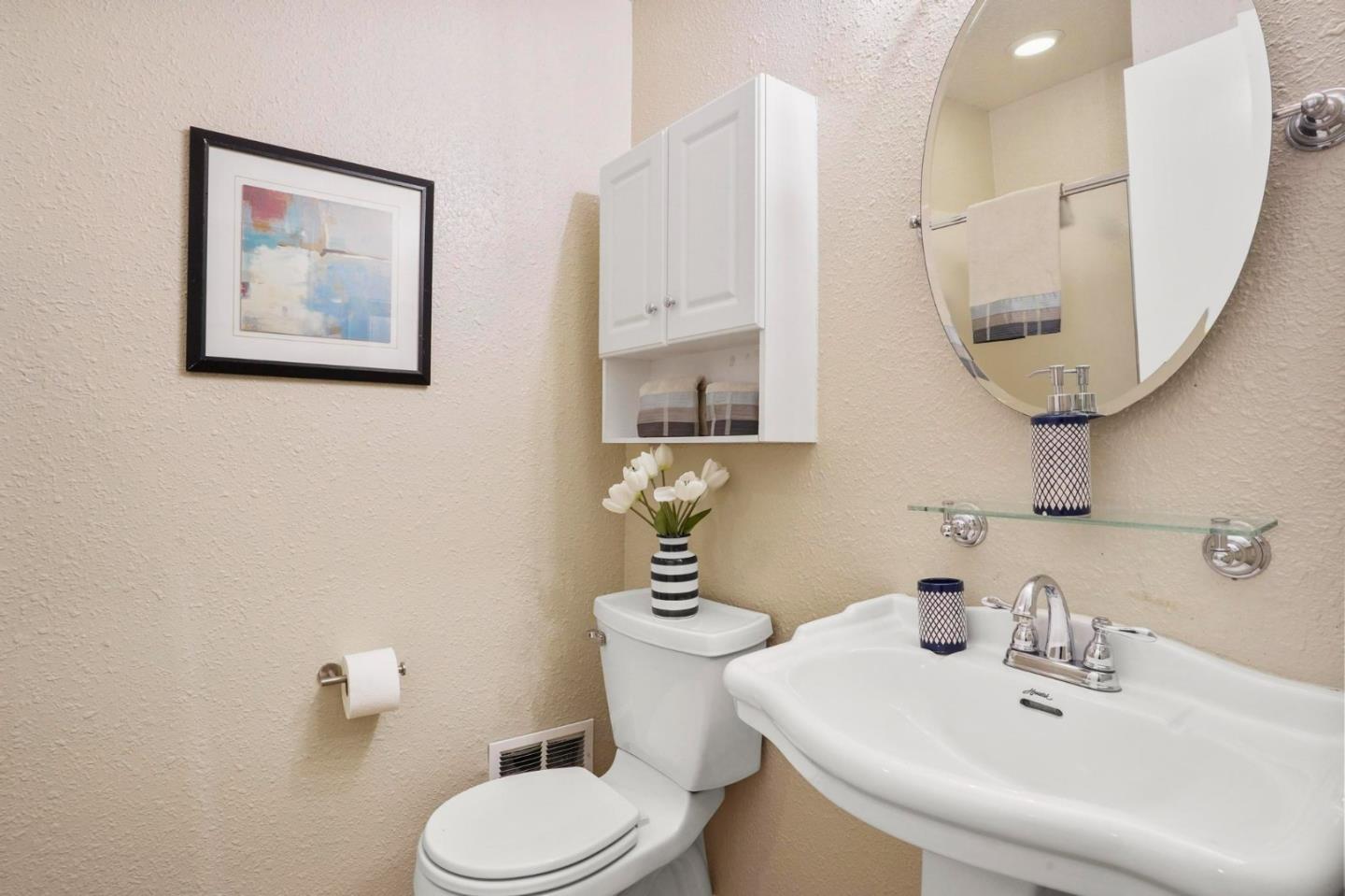 120 Castleton Court San Ramon, CA 94583 - Photo 12 of 30 a bathroom with a toilet a sink and mirror