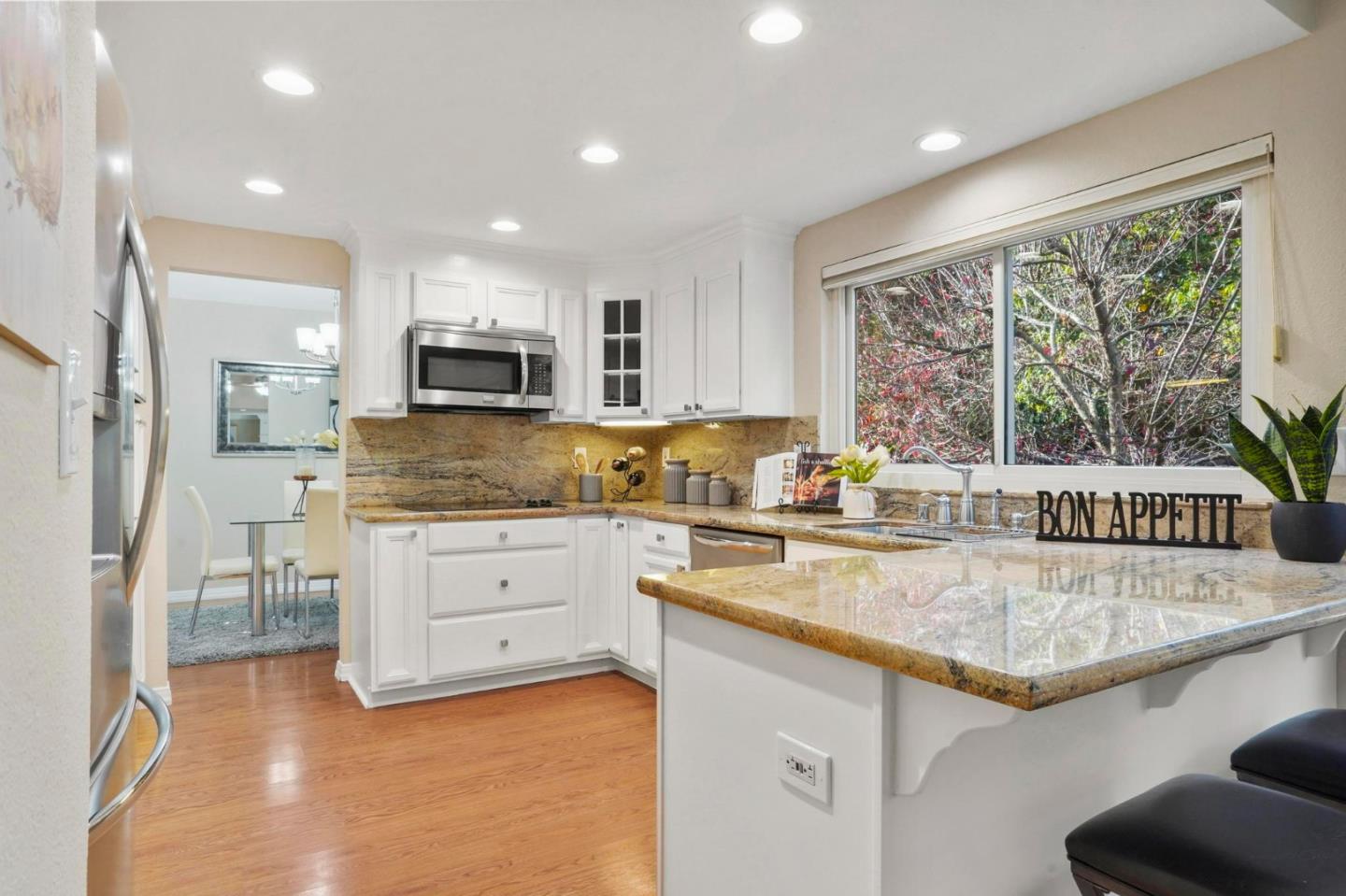 120 Castleton Court San Ramon, CA 94583 - Photo 8 of 30 a kitchen with granite countertop a stove a sink a oven a dining table and chairs