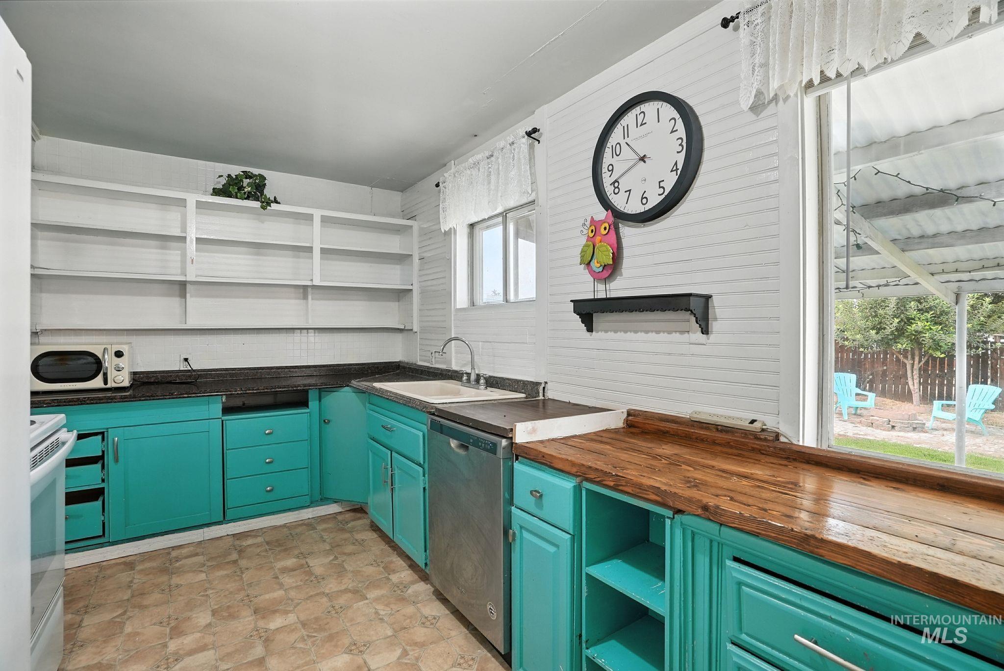 3506 10th Street Lewiston, ID 83501 - Photo 16 of 40 Kitchen featuring open shelves, stainless steel dishwasher, white range with electric stovetop, wood counters, and green cabinets