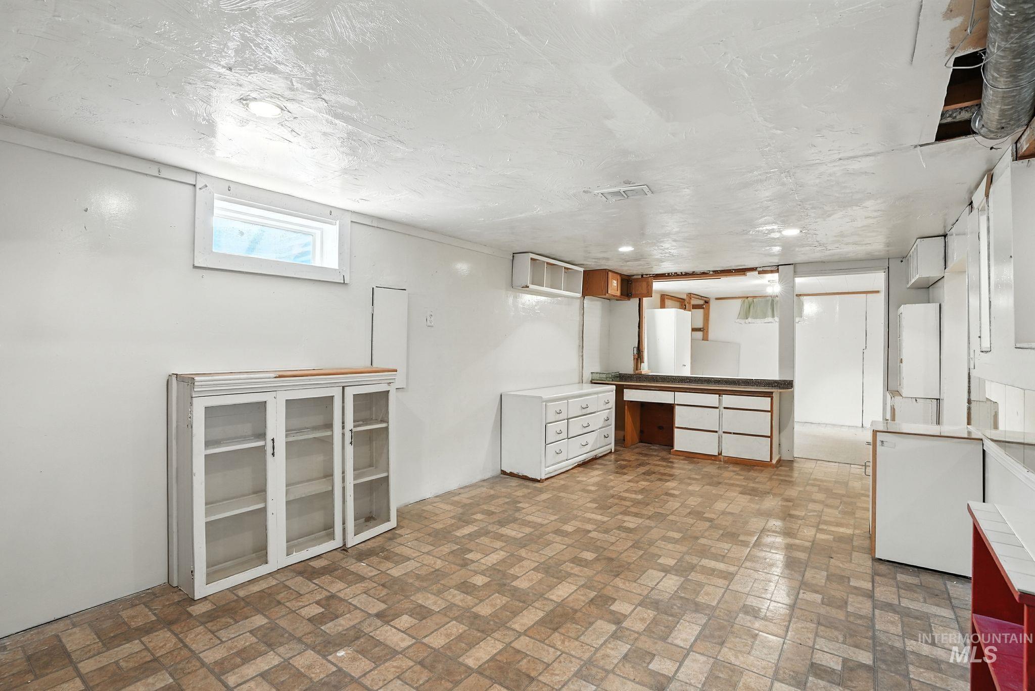 3506 10th Street Lewiston, ID 83501 - Photo 24 of 40 Basement with brick patterned flooring and a textured ceiling