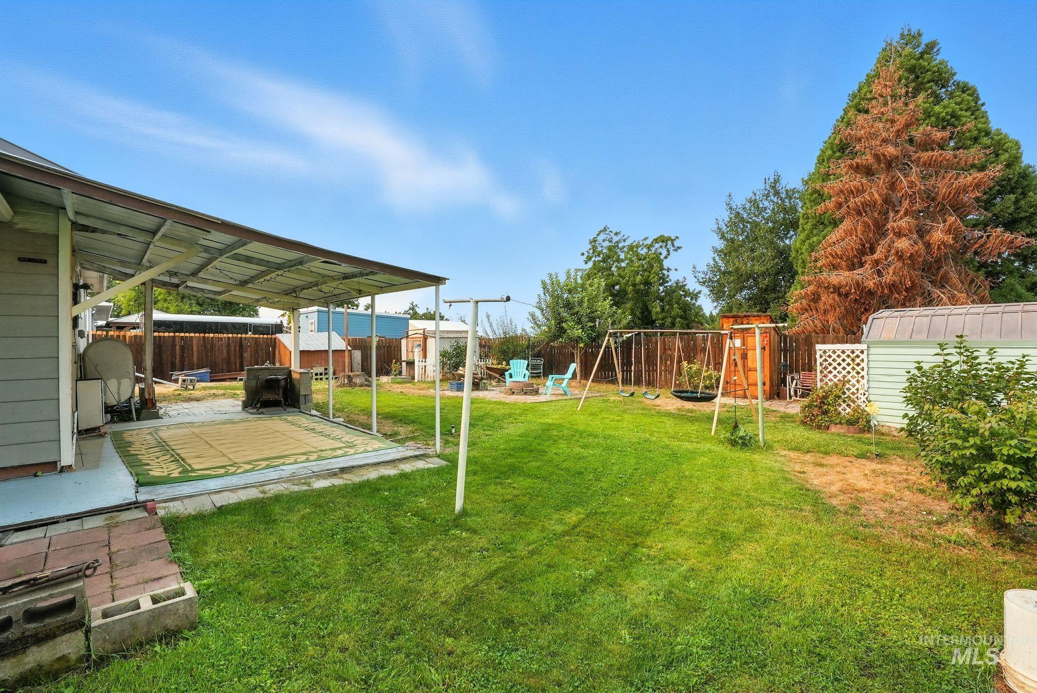 3506 10th Street Lewiston, ID 83501 - Photo 35 of 40 Fenced backyard featuring a playground, a patio area, and a storage shed