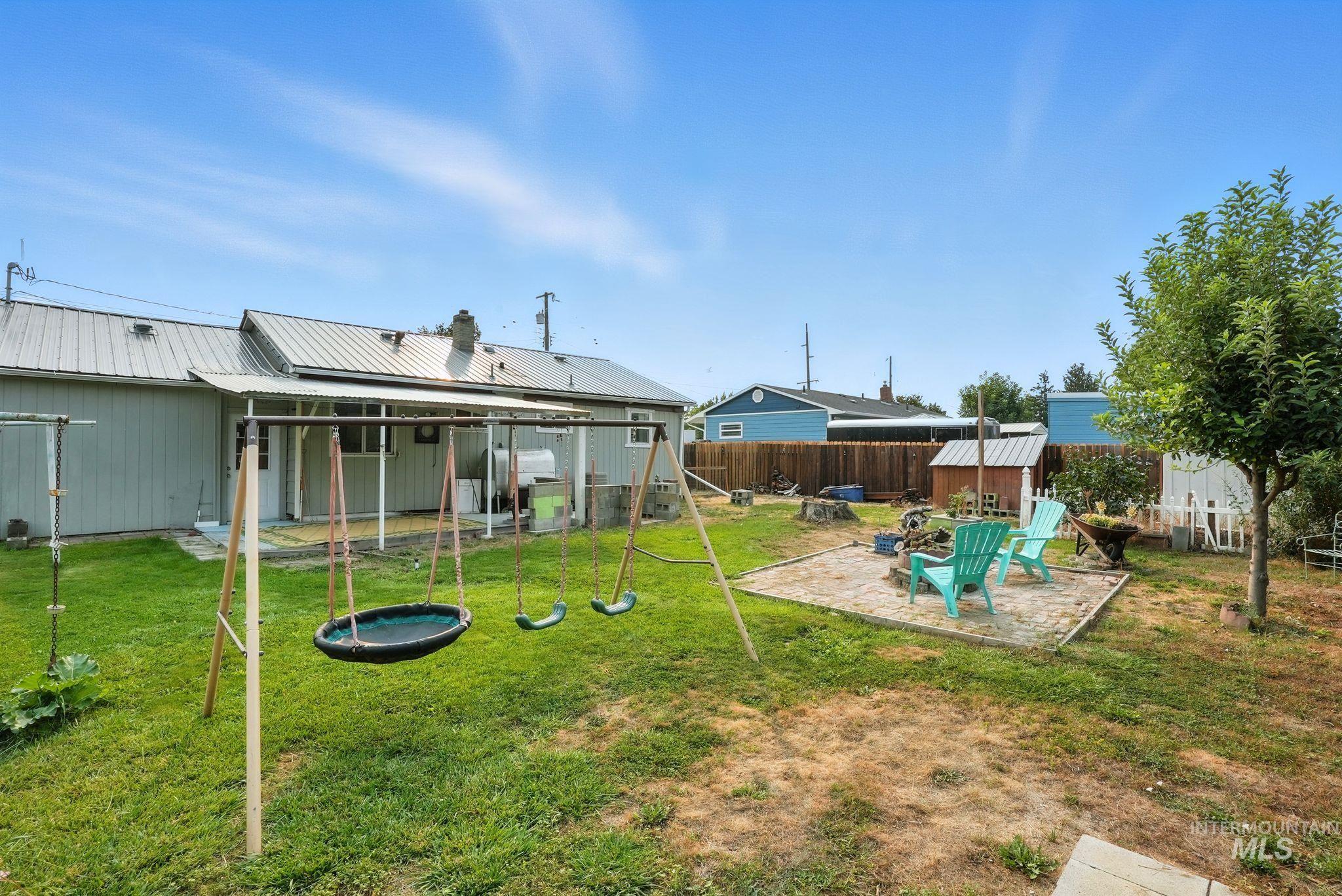 3506 10th Street Lewiston, ID 83501 - Photo 36 of 40 Fenced backyard featuring a patio area, a playground, and a storage shed