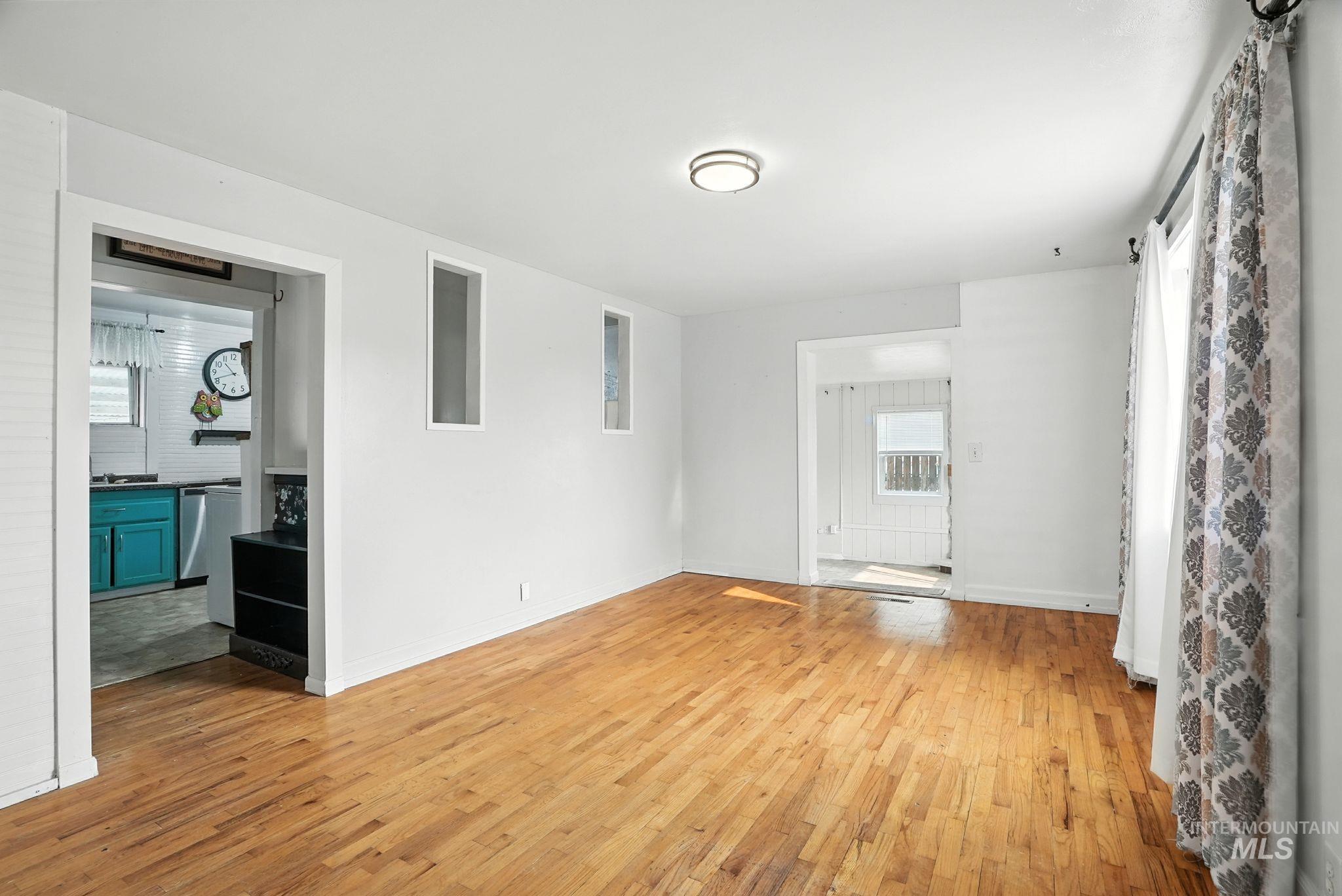 3506 10th Street Lewiston, ID 83501 - Photo 5 of 40 Unfurnished living room with light wood-style floors and baseboards