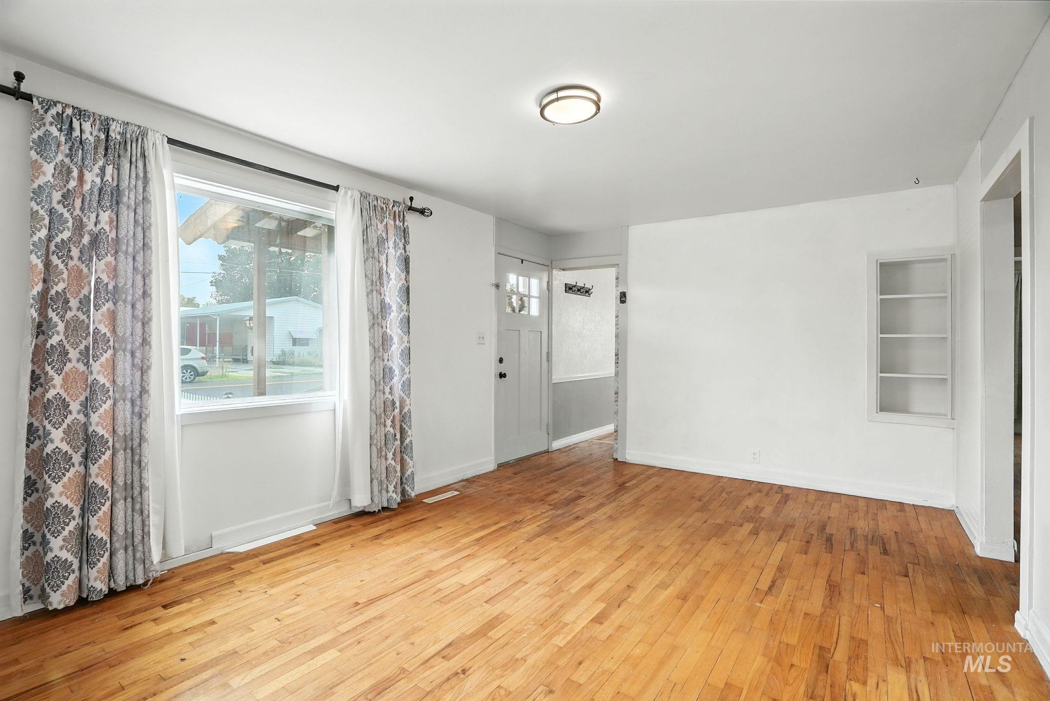 3506 10th Street Lewiston, ID 83501 - Photo 7 of 40 Empty room featuring light wood-style floors and built in shelves