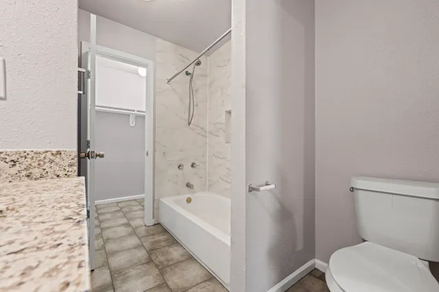 a bathroom with a bathtub and a toilet