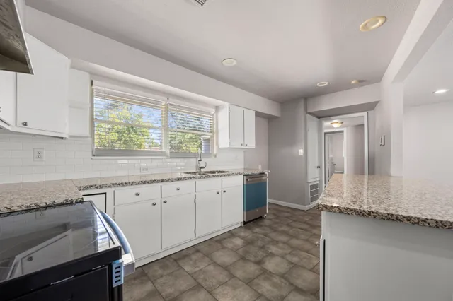 a large bathroom with a granite countertop sink and a mirror