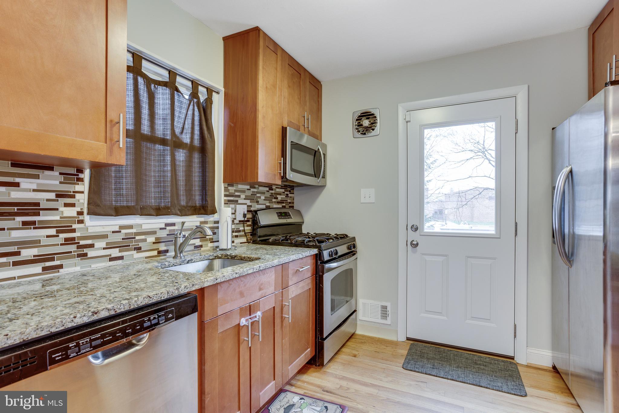 13307 Galvez Street Silver Spring, MD 20906 - Photo 11 of 32 Gas Stove, access to new deck and backyard