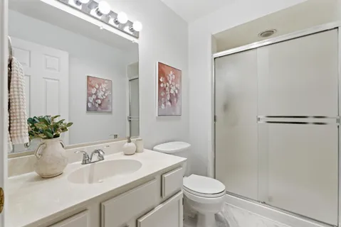 a bathroom with a sink toilet and a mirror