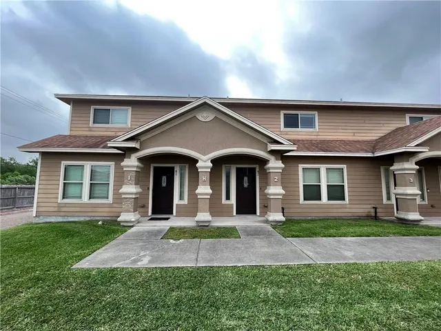 front view of a house with a yard