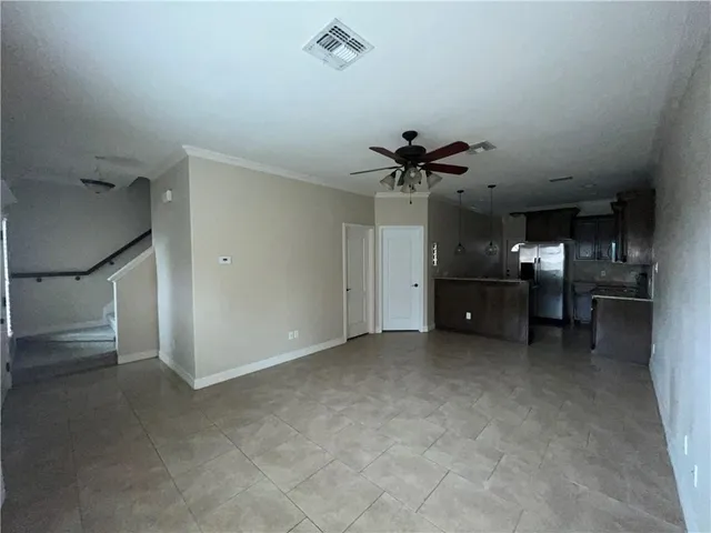 a view of a livingroom with furniture and a ceiling fan