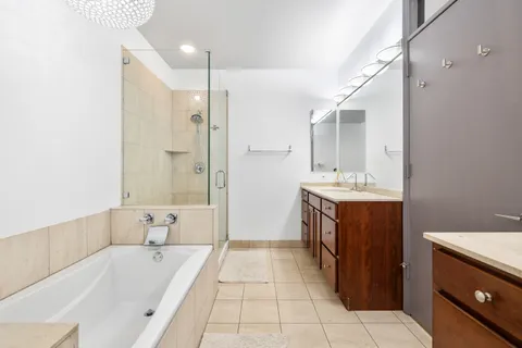 a bathroom with a tub sink and mirror