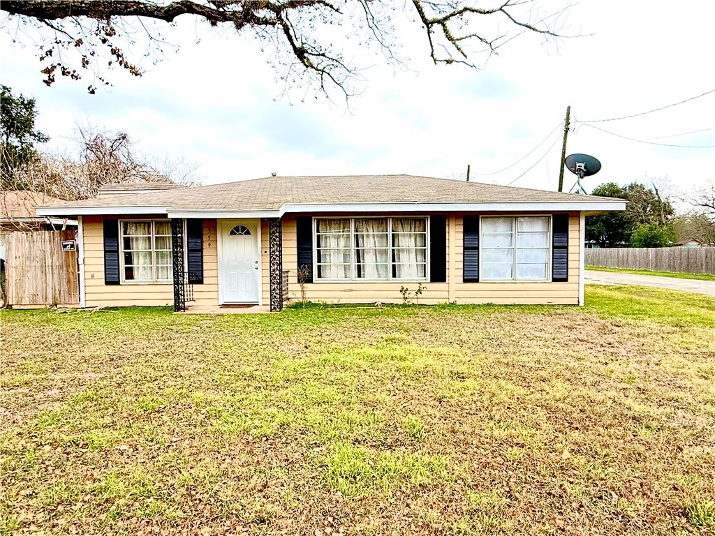 359 6th Street Somerville, TX 77879 - Photo 1 of 17 a front view of a house with a garden