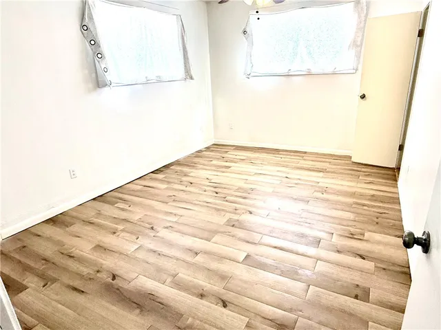 a bathroom with a granite countertop shower and a toilet