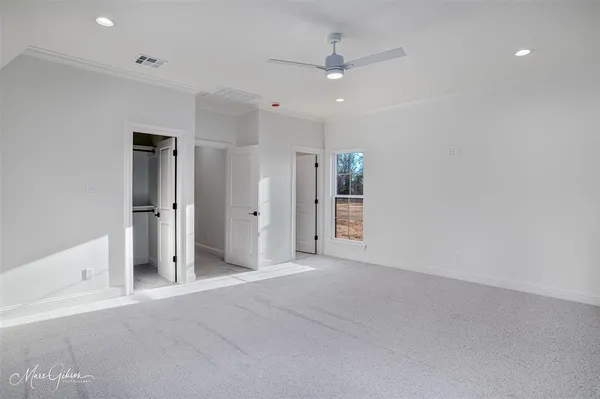 an empty room with a bathroom and a shower