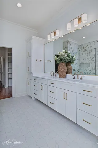 a spacious bathroom with double sink and a mirror