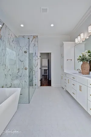 a large spacious bathroom with a tub shower and mirror